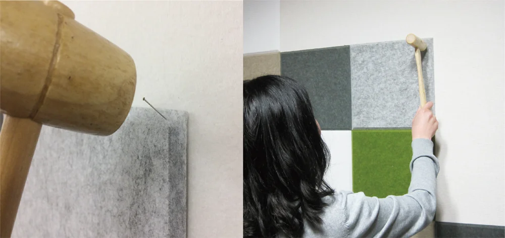 フェルメノンを木槌とピンで壁に取り付ける様子